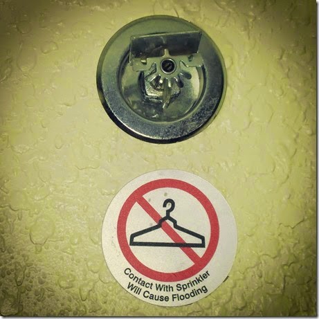 Image of warning sign not to hang clothes on fire sprinkler